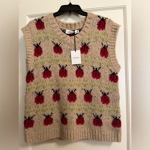 “FALL ESSENTIAL” Beautiful vest by COACH with ladybug detail.